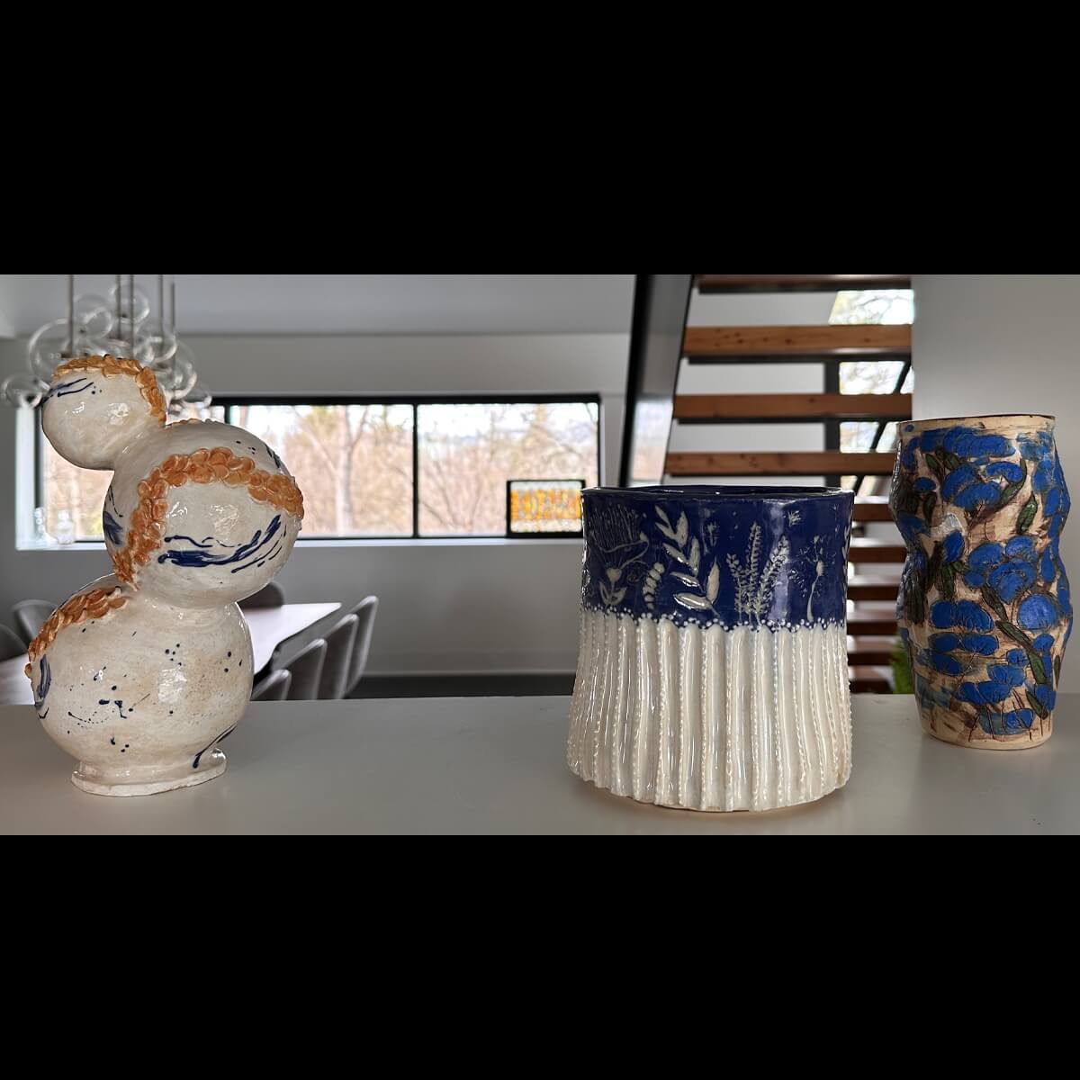 Student sculpture titled "Surface Techniques" and "Enclosed"
