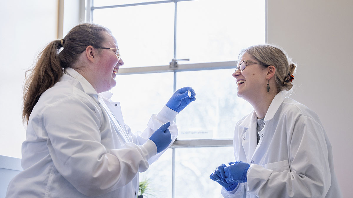 Two women wearing lab coats.